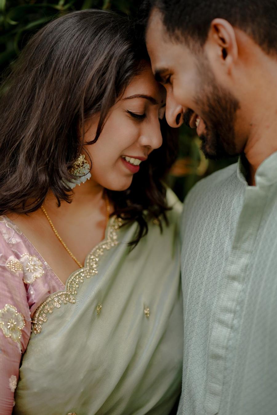 Arvind and Rinu, foreheads touching and smiling