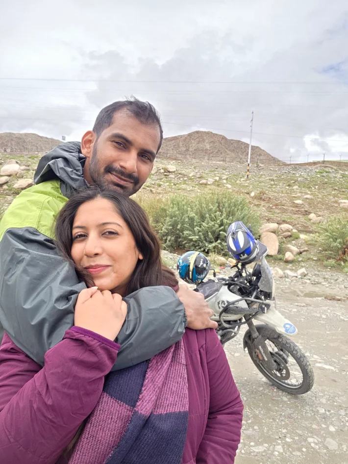 Arvind and Rinu on a mountain road trip beside their motorbike